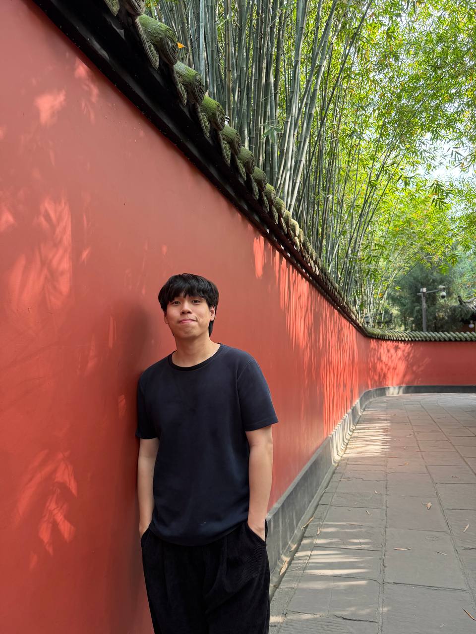 Ryan against a red temple wall